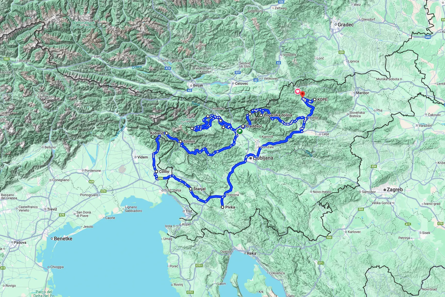 Topographic map showing a marked blue road trip route through Slovenia, passing locations including Ljubljana, Pivka, Štanjel, Collio, Kobarid, Tolmin, Logarska Dolina, Predvor, and ending at Kope.